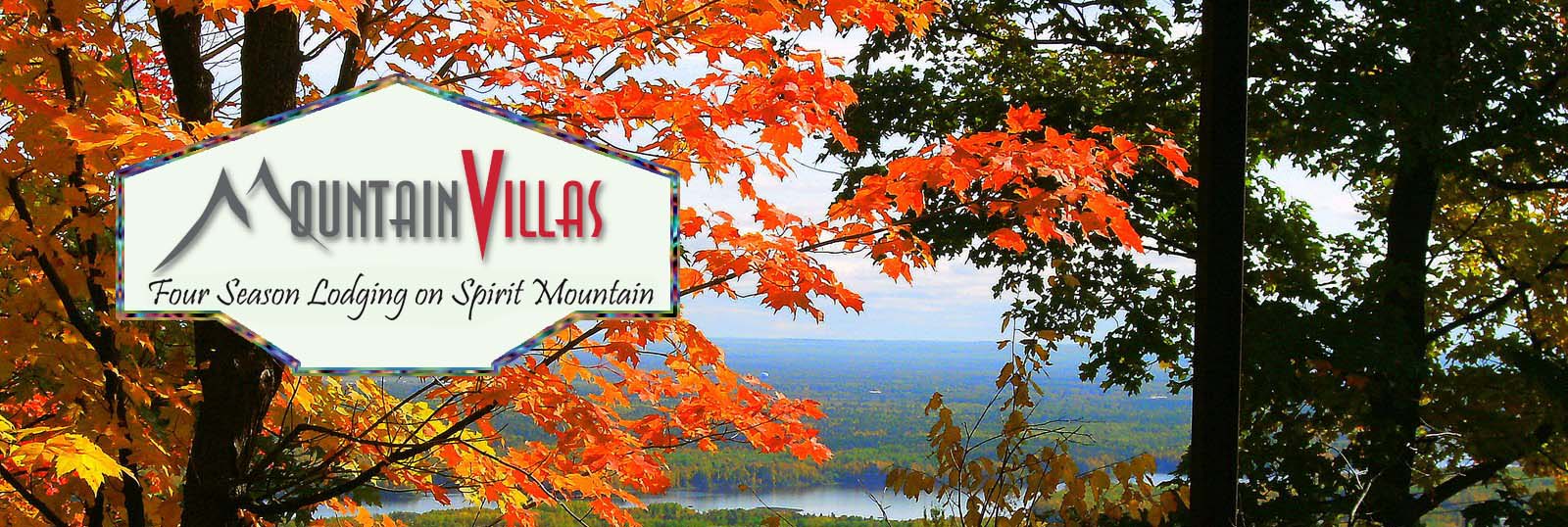 Mountain Villas Logo saying Four Season Lodging on Spirit Mountain, is superimposed on a view of Saint Louis Bay on a beautiful autumn day at Mountain Villas
